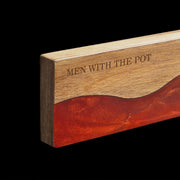 Close-up of the acacia grain and ember-red resin on the magnetic knife strip