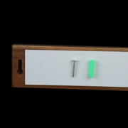 Back of the magnetic knife strip with adhesive pad, screw, and wall anchor