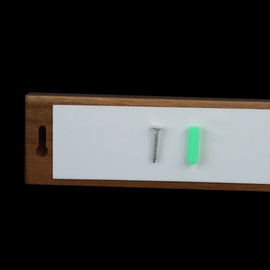 Back of the magnetic knife strip with adhesive pad, screw, and wall anchor
