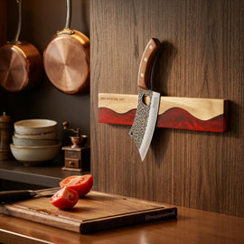 ember-red magnetic knife strip mounted in a kitchen with a knife attached