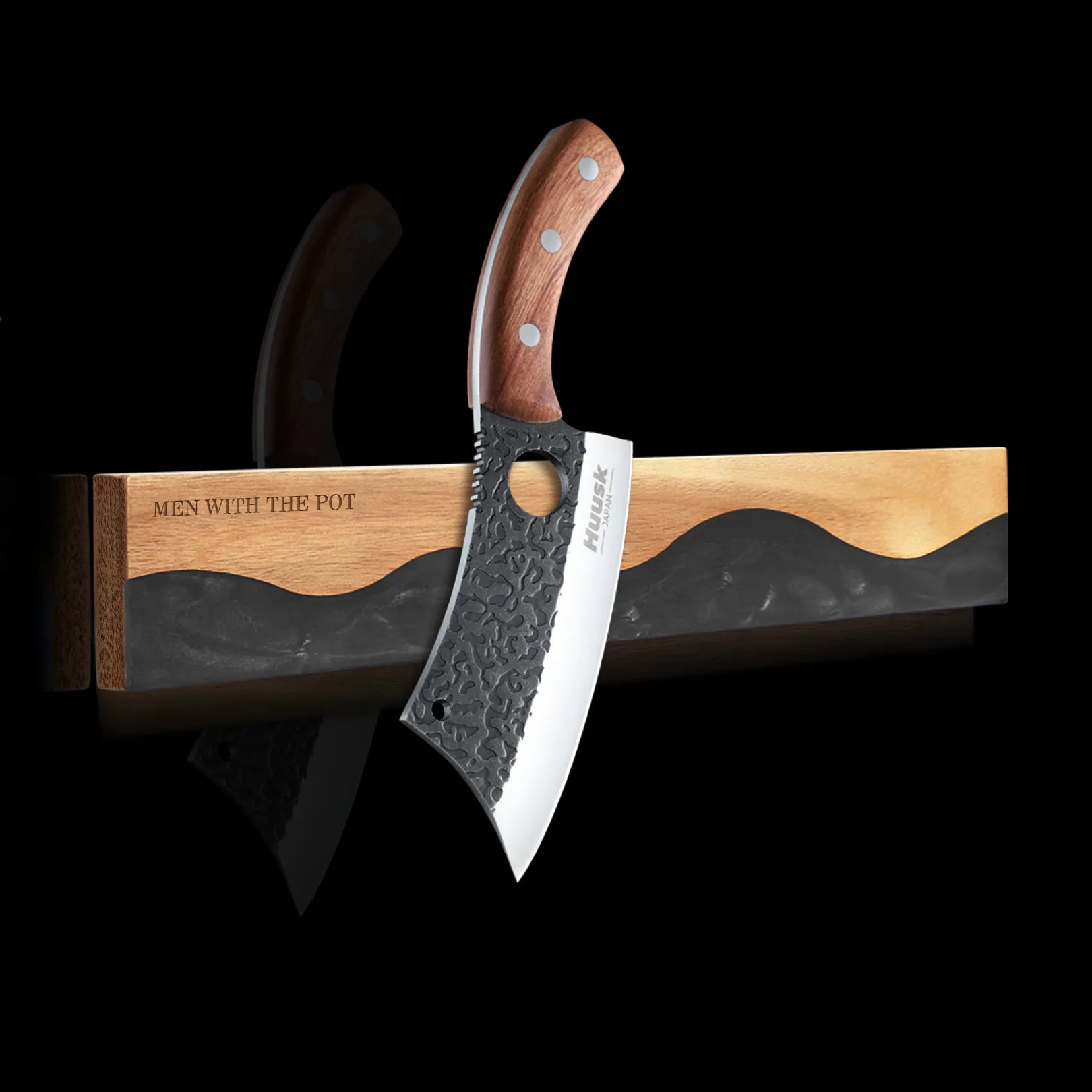 obsidian-black wall-mounted magnetic knife strip holding a kitchen knife