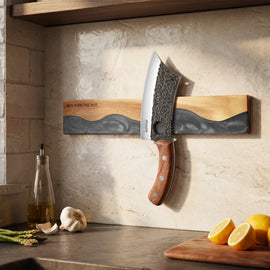 obsidian-black wall-mounted magnetic knife strip in a home kitchen