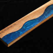 Close-up of the ocean-blue resin river detail in the acacia knife strip