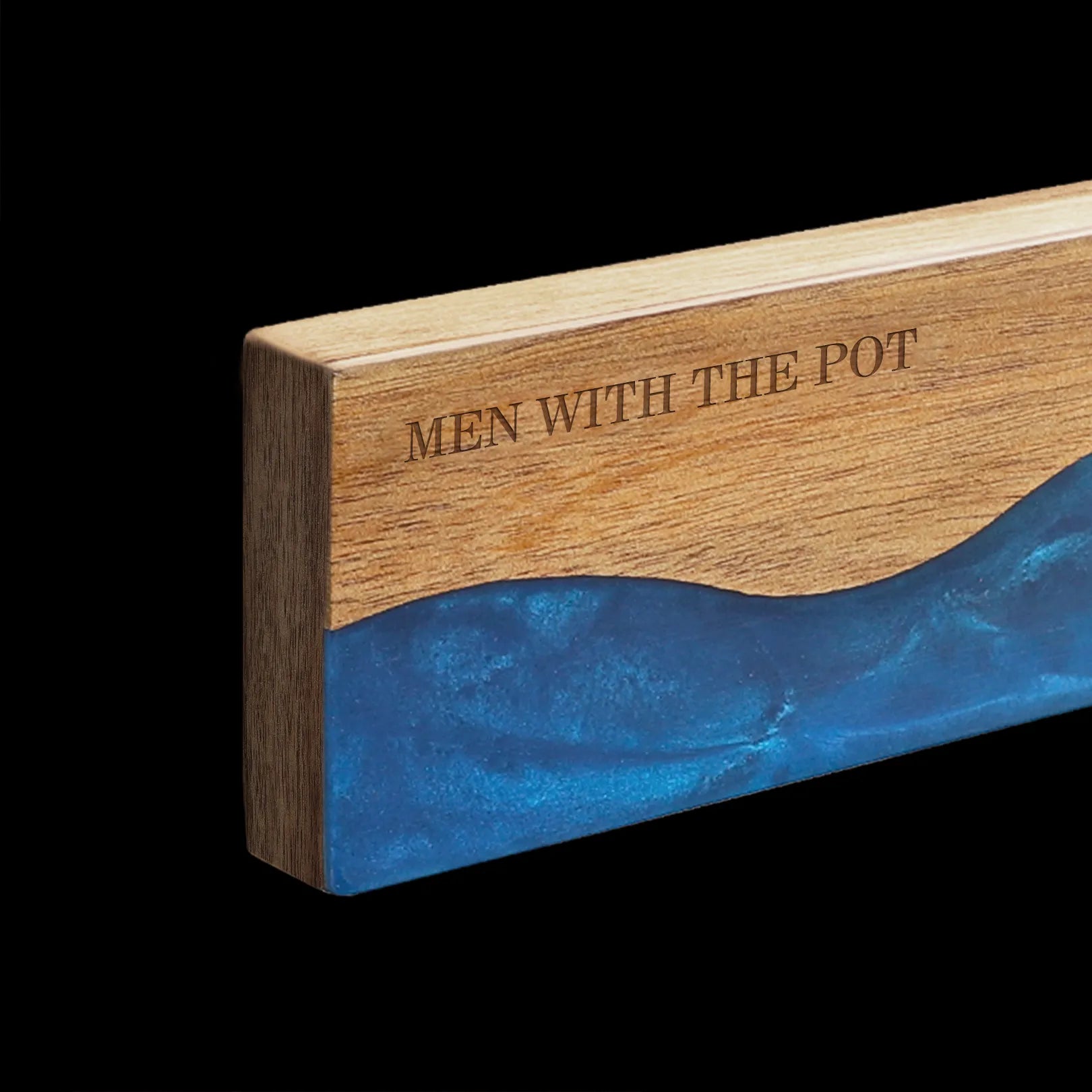 Close-up of the acacia grain and ocean-blue resin on the magnetic knife strip