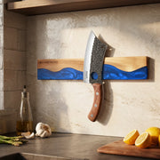 ocean-blue wall-mounted magnetic knife strip in a home kitchen