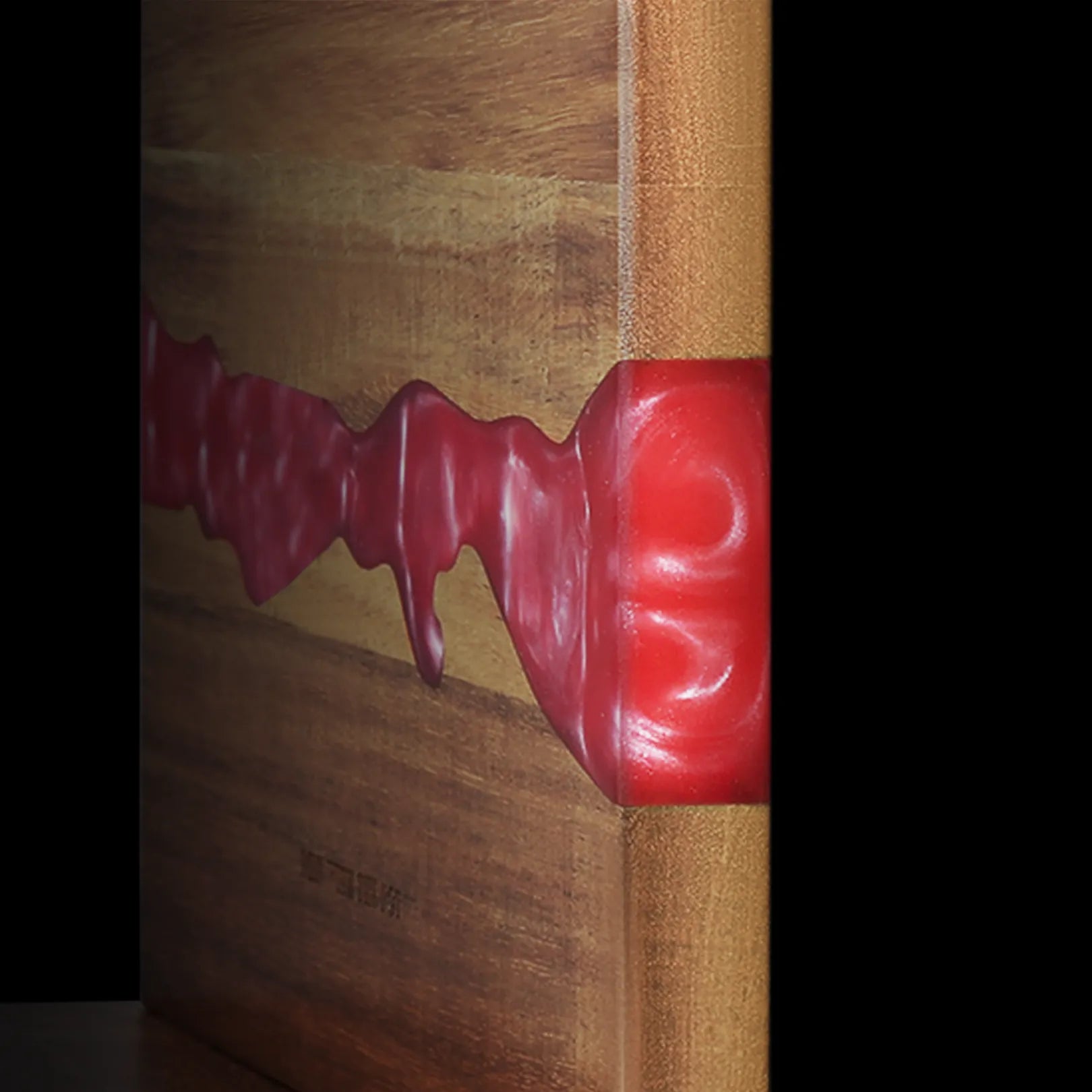 Close-up of the acacia grain and ember-red resin on the magnetic knife block