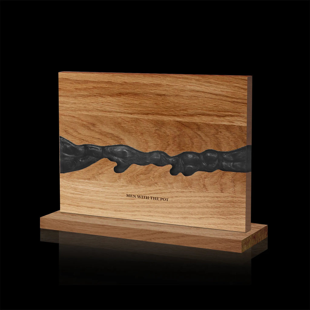 obsidian-black acacia and resin double-sided magnetic knife block on its countertop base