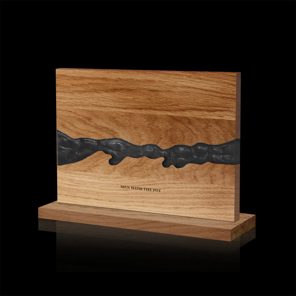 obsidian-black acacia and resin double-sided magnetic knife block on its countertop base