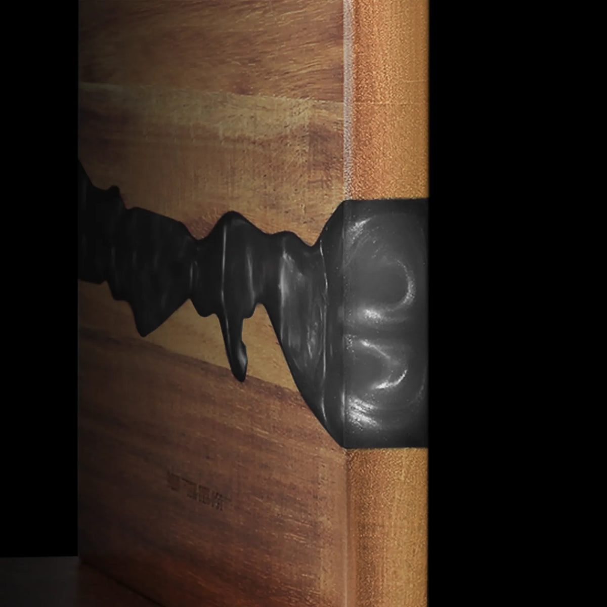 Close-up of the acacia grain and obsidian-black resin on the magnetic knife block