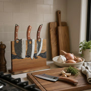 obsidian-black magnetic knife block holding three knives on a kitchen counter