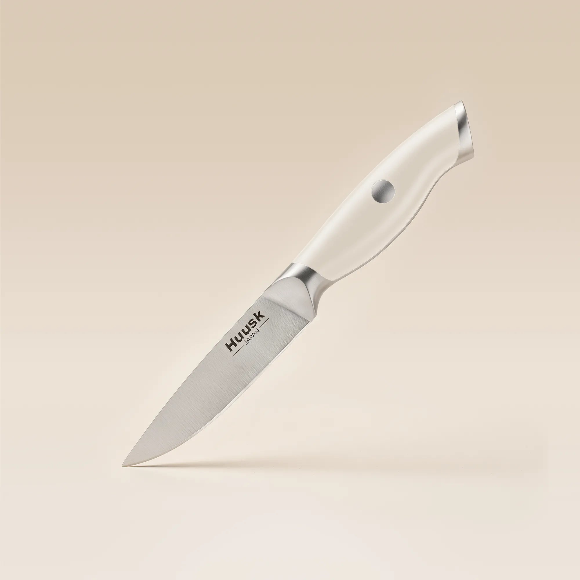 Huusk 3.5-inch paring knife with an ivory resin handle and high-carbon stainless steel blade