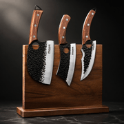 Huusk three-piece forged knife set standing upright in a wooden display block.