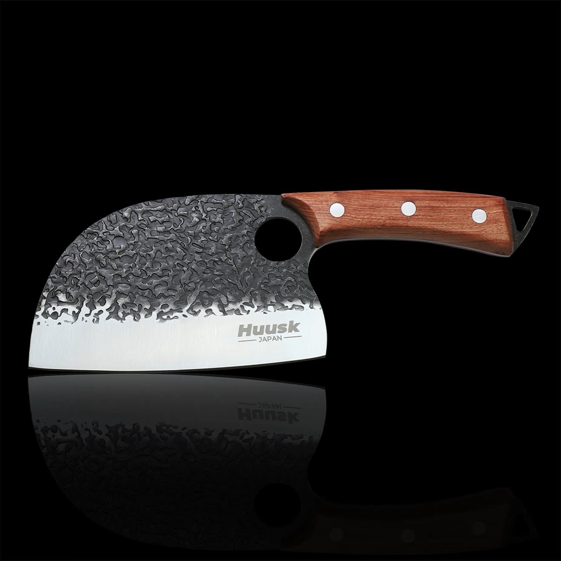 Huusk hand-forged cleaver with hammered black blade and riveted wood handle.