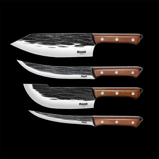 Huusk four-piece forged kitchen knife set with cleaver, chef, boning, and fillet blades on black.