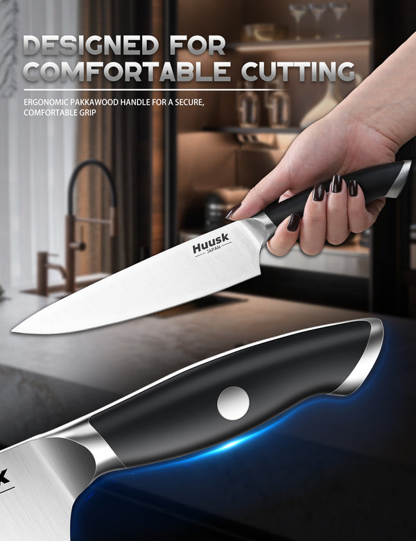 Close view of the ergonomic black Pakkawood handle on a Huusk kitchen knife