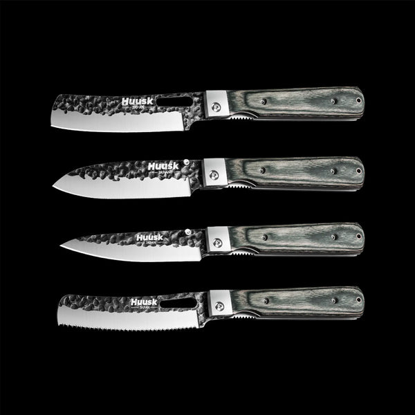 Four Huusk folding kitchen knives with dark camo handles and different blade shapes on black.