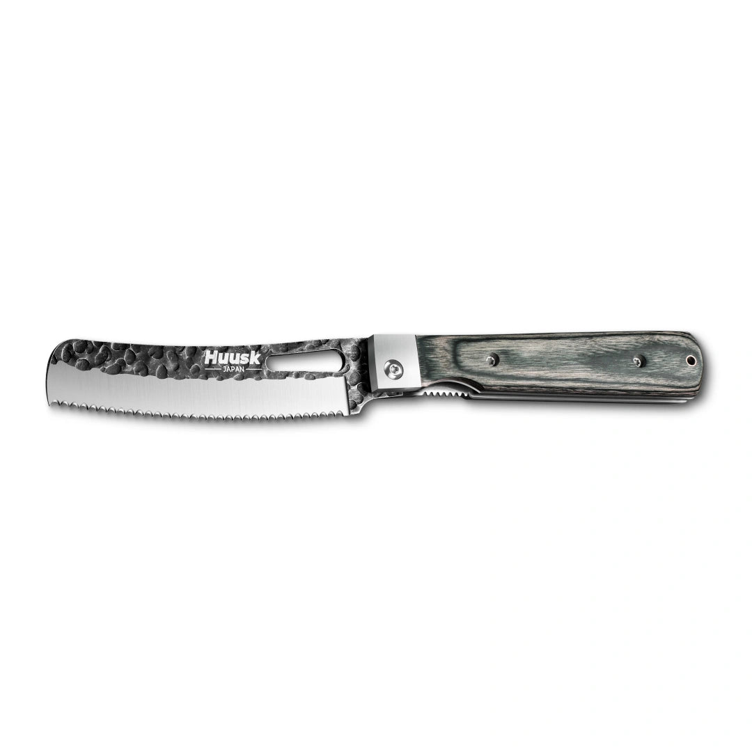Huusk camo folding bread knife fully open in a side view on white.