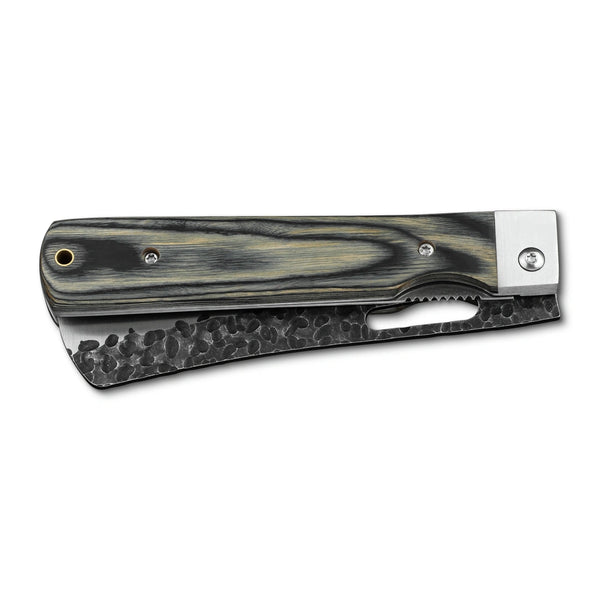Huusk camo folding bread knife closed with the serrated blade stored in the handle.