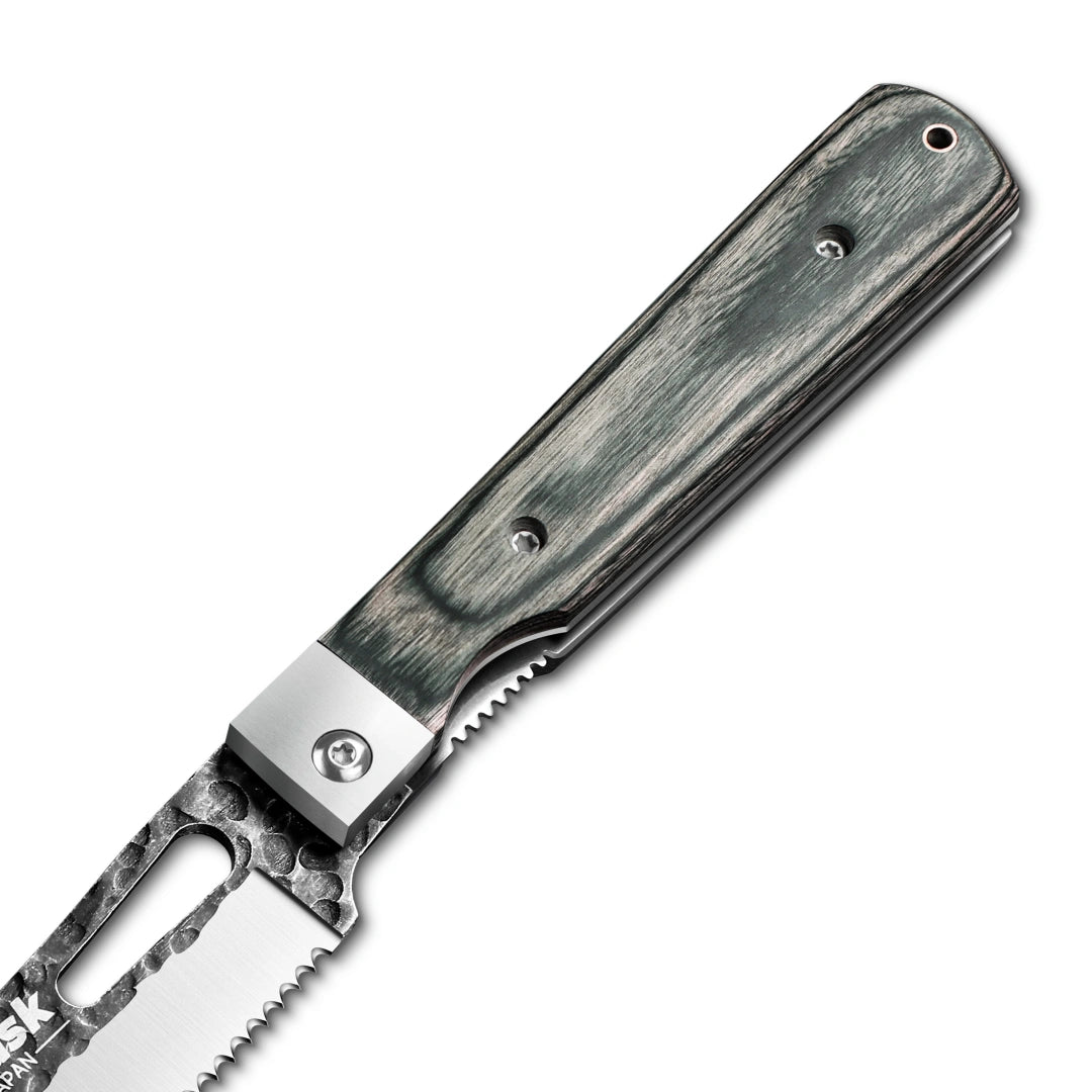 Close-up of the Huusk camo folding bread knife pivot and textured handle.