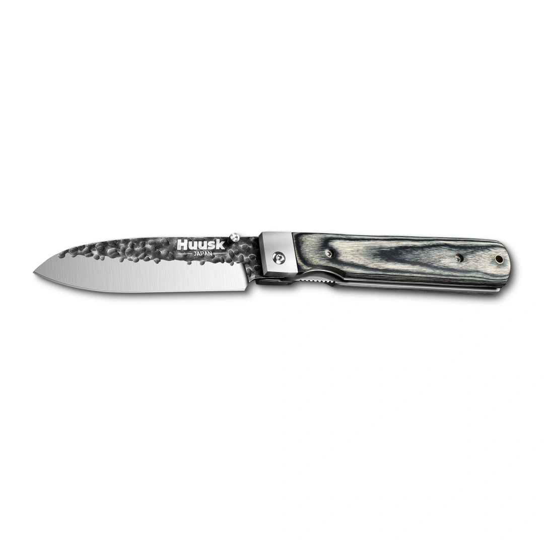 Huusk camo folding chef knife fully open in a side view on white.
