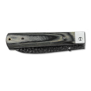 Huusk camo folding chef knife closed with the blade nested inside the handle.