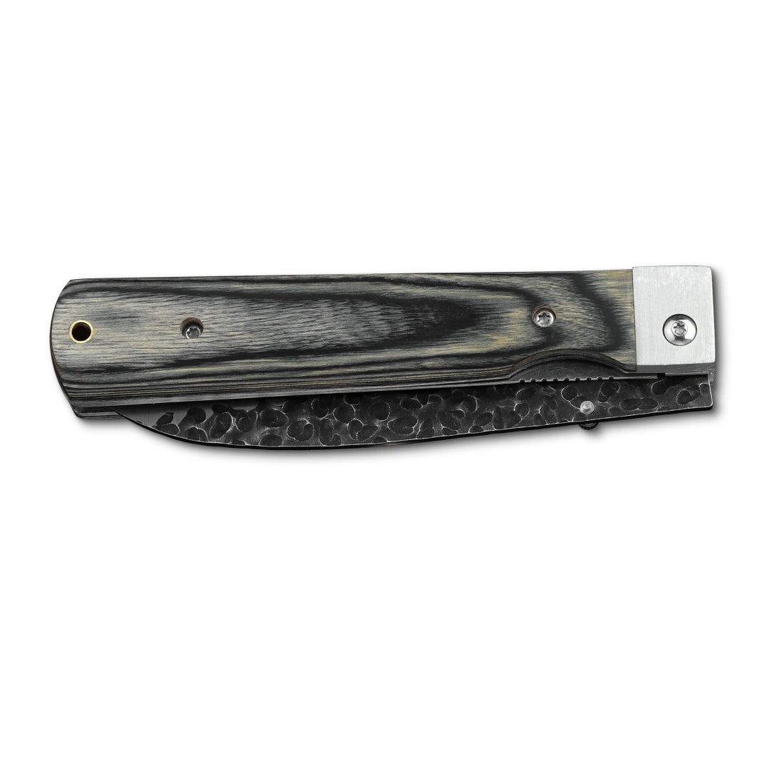 Huusk camo folding chef knife closed with the blade nested inside the handle.