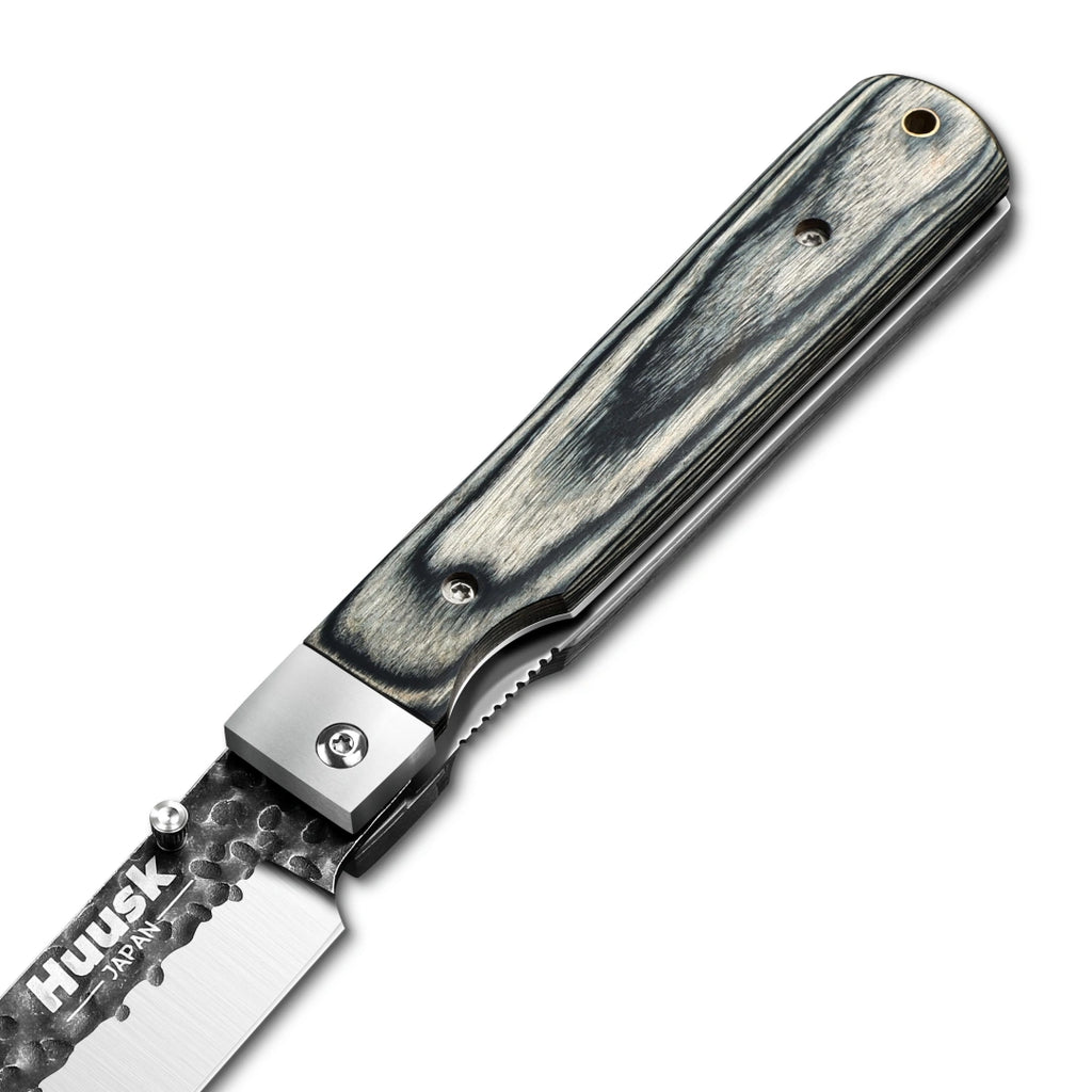 Close-up of the Huusk camo folding chef knife pivot and handle grain.