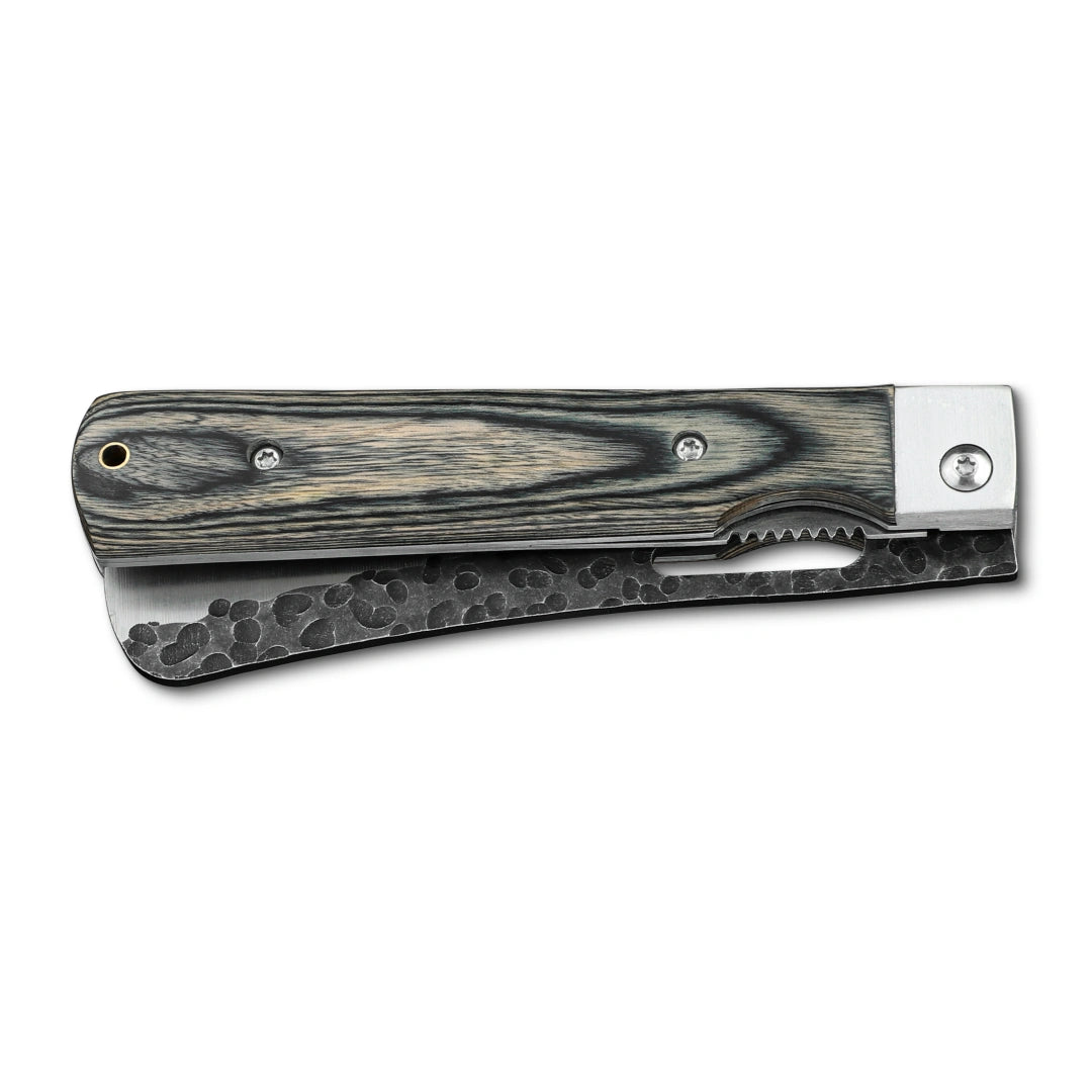 Huusk camo folding cleaver closed with the broad blade stored in the handle.