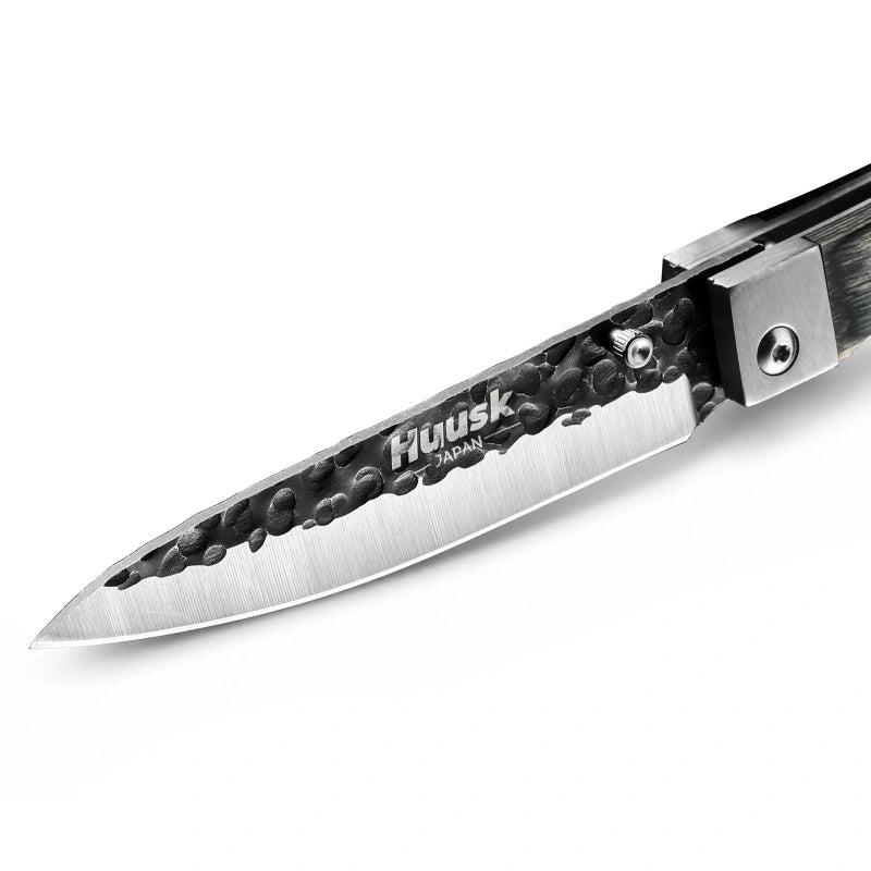 Close-up of the Huusk camo folding paring knife blade and polished edge.