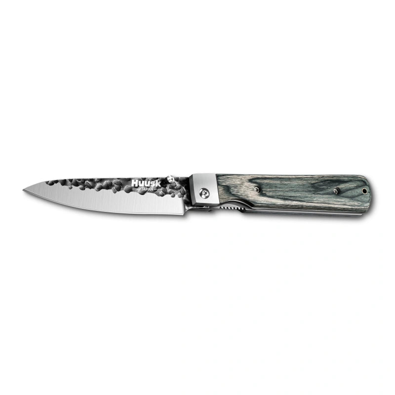 Huusk camo folding paring knife fully open in a side view on white.