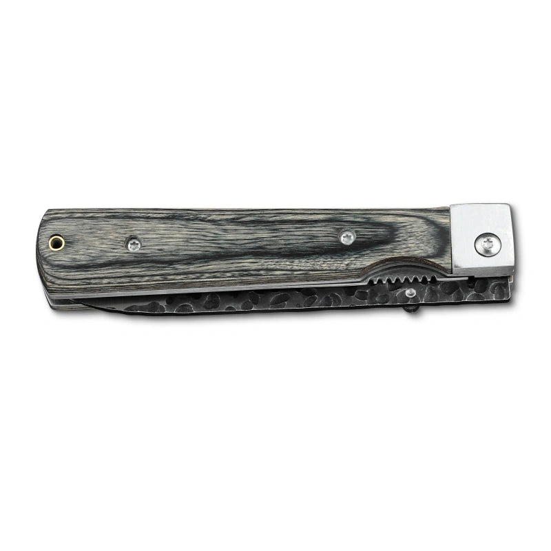 Huusk camo folding paring knife closed with the compact blade stored in the handle.