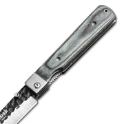 Close-up of the Huusk camo folding paring knife pivot and handle texture.