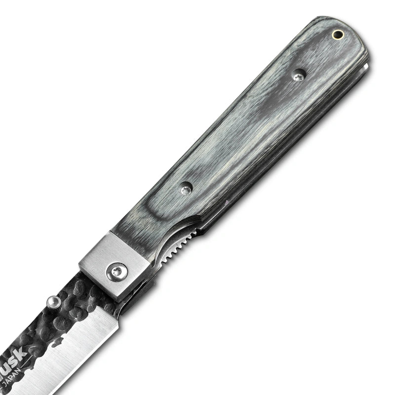 Close-up of the Huusk camo folding paring knife pivot and handle texture.