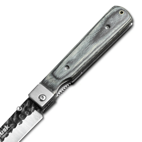 Close-up of the Huusk camo folding paring knife pivot and handle texture.