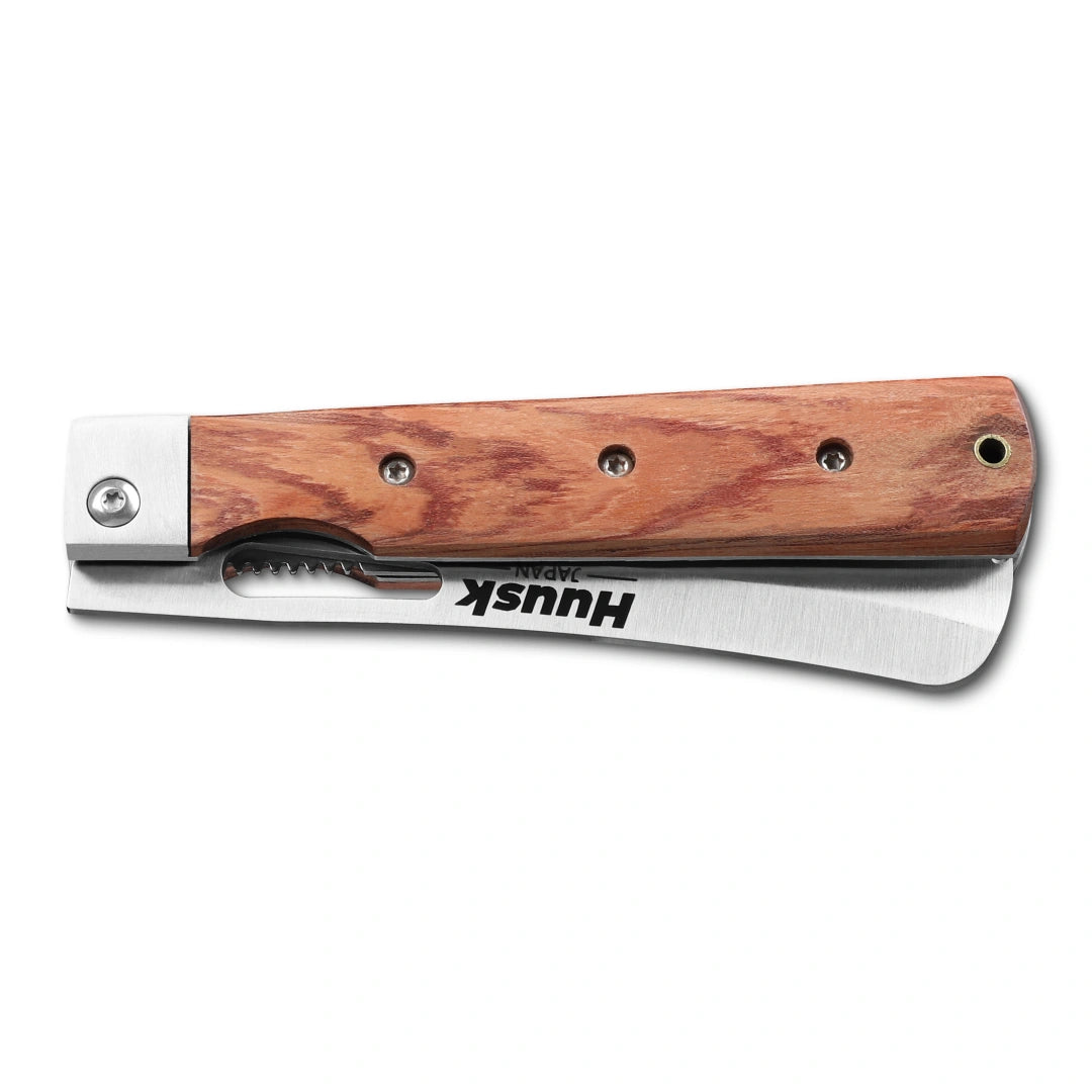 Huusk natural wood folding bread knife closed with the blade stored in the handle.