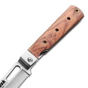 Close-up of the Huusk natural wood folding bread knife pivot and blade slot.