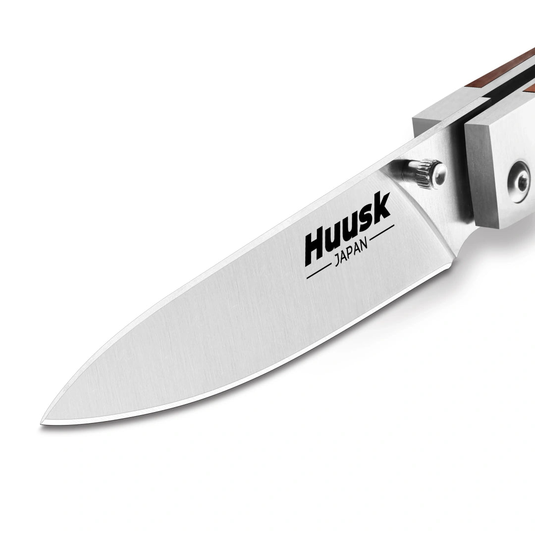 Close-up of the Huusk natural wood folding paring knife's compact blade.