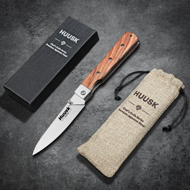 Huusk natural wood folding paring knife displayed with its gift box and storage pouch.