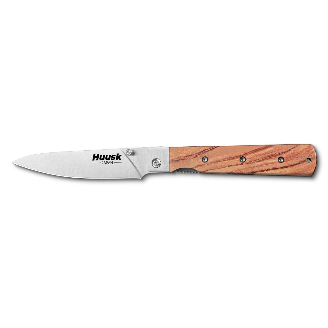 Huusk natural wood folding paring knife fully open in a side view on white.