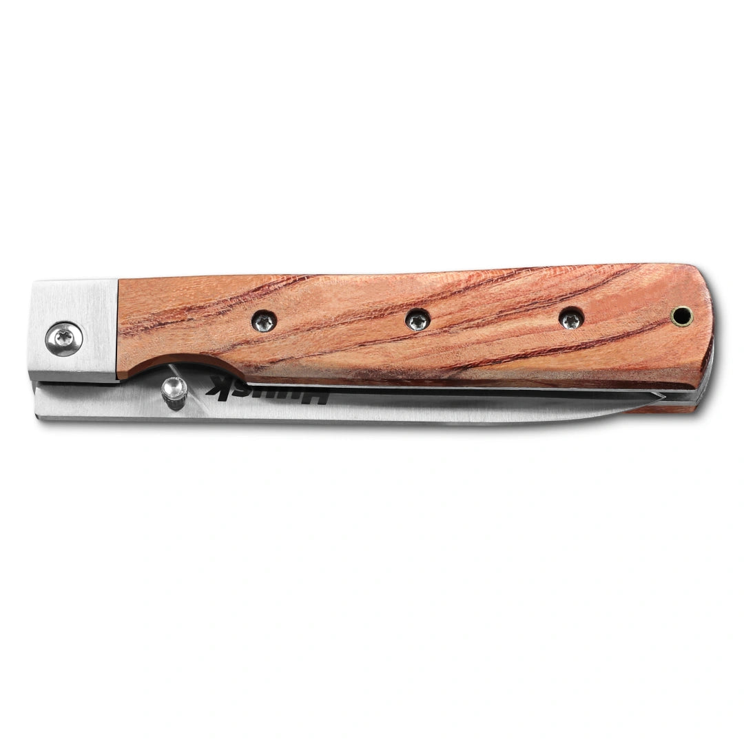 Huusk natural wood folding paring knife closed with the blade nested in the handle.