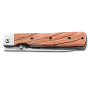 Huusk natural wood folding paring knife closed with the blade nested in the handle.