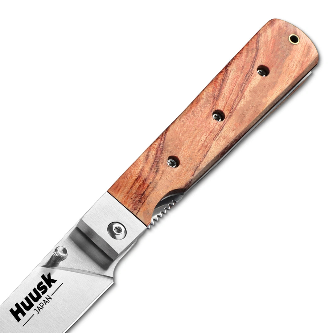 Close-up of the Huusk natural wood folding paring knife pivot and wood grain.