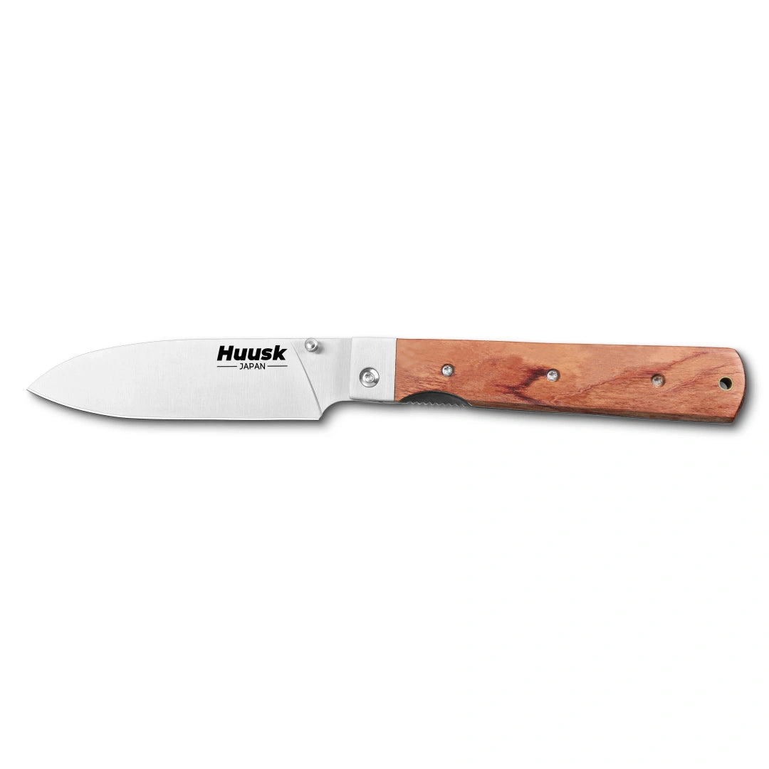 Huusk natural wood folding chef knife fully open in a side view on white.
