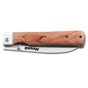 Huusk natural wood folding chef knife closed with the blade stored in the handle.