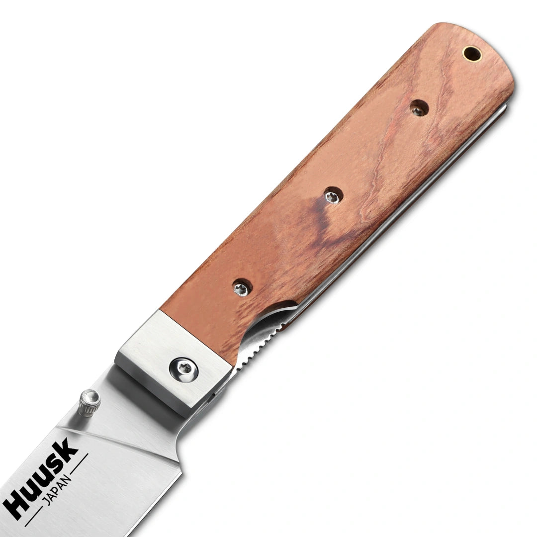 Close-up of the Huusk natural wood folding chef knife pivot and riveted handle.