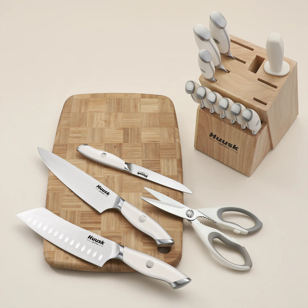 Huusk white kitchen knife set stored in a wooden block on a countertop