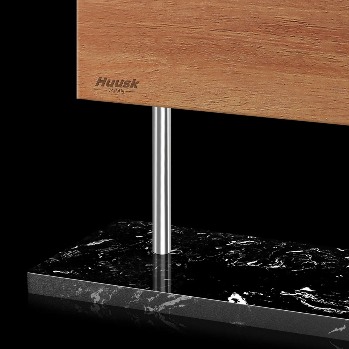 Close-up of the acacia panel, steel supports, and black marble base