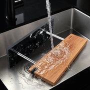 Removable parts of the marble-base magnetic knife stand being rinsed
